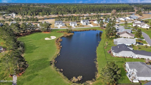 drone / aerial view featuring a water view, a residential view, and a view of trees
