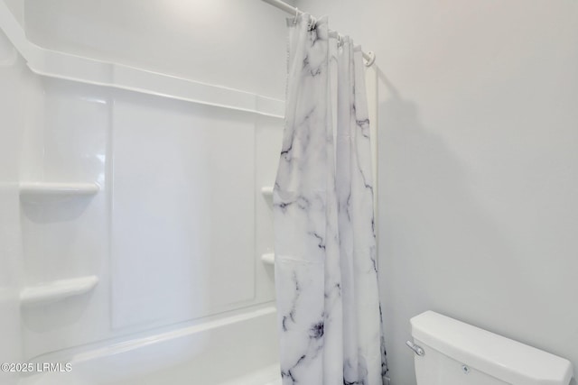 full bathroom with toilet and a shower with curtain