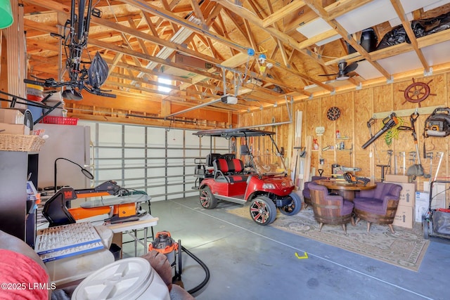 garage with a garage door opener and wooden walls