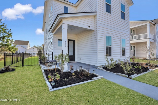 entrance to property with fence and a lawn