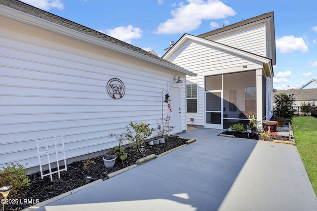 exterior space with a patio area and a sunroom