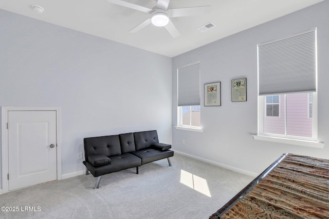 sitting room featuring carpet floors, visible vents, baseboards, and a ceiling fan
