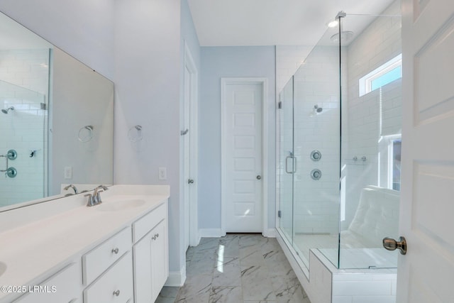 bathroom featuring a stall shower, marble finish floor, vanity, and baseboards