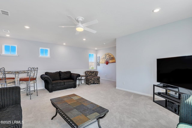 carpeted living area with recessed lighting, plenty of natural light, visible vents, and baseboards