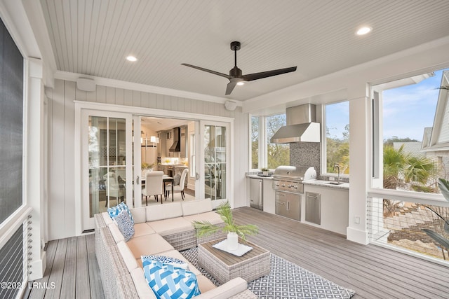 sunroom / solarium featuring sink and ceiling fan