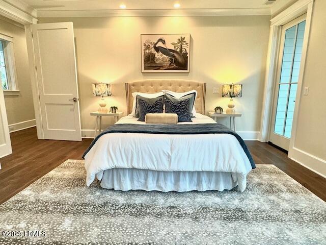 bedroom featuring ornamental molding and dark hardwood / wood-style floors