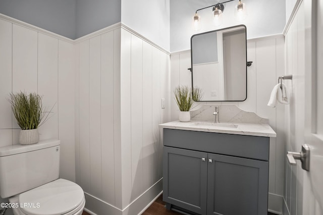 bathroom featuring vanity and toilet