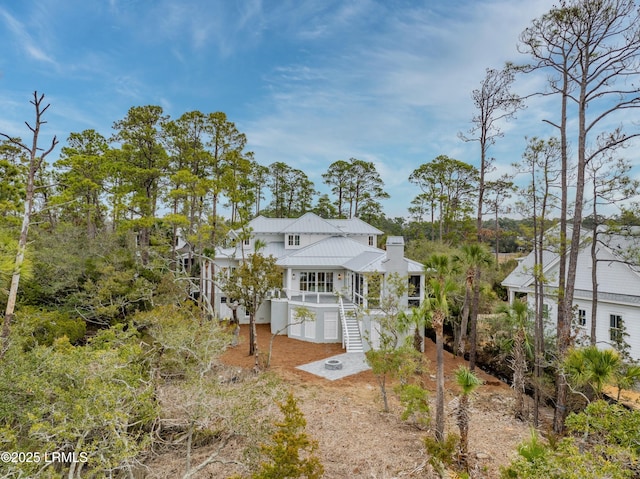 rear view of property with covered porch