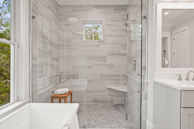 bathroom featuring ornamental molding, plus walk in shower, and vanity