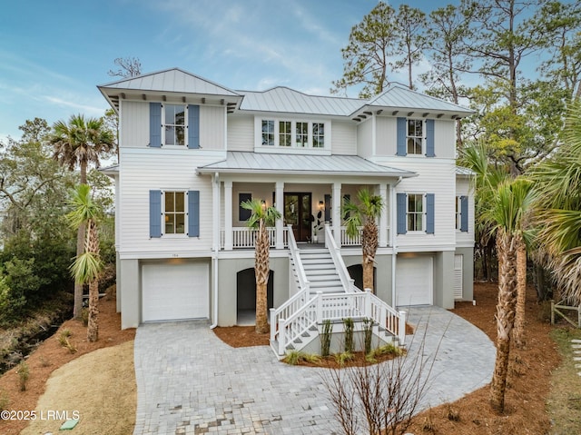 raised beach house with a garage and a porch