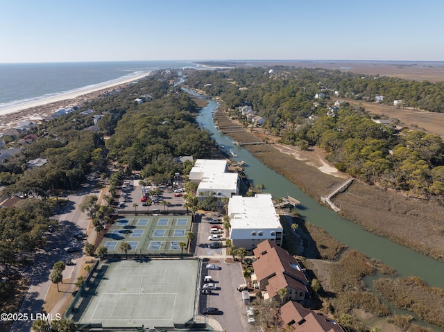 drone / aerial view with a water view and a beach view