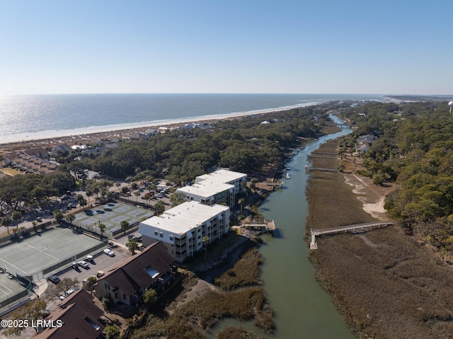 drone / aerial view with a beach view and a water view