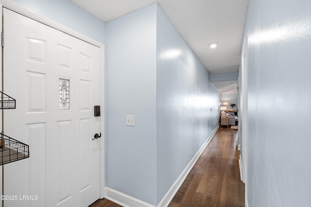 hall with dark wood-type flooring