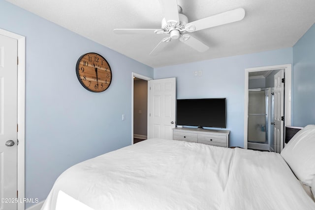 bedroom with ceiling fan and a textured ceiling