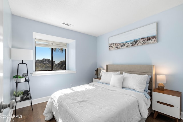 bedroom with dark hardwood / wood-style floors