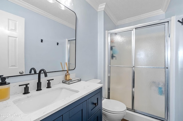 bathroom with toilet, crown molding, a textured ceiling, vanity, and a shower with door