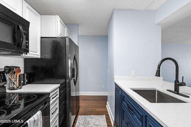 kitchen featuring blue cabinetry, dark wood-type flooring, sink, black appliances, and white cabinets