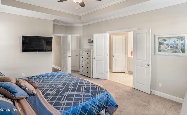 bedroom featuring carpet flooring, ornamental molding, baseboards, a raised ceiling, and a ceiling fan