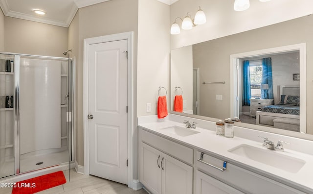 bathroom with double vanity, a sink, ornamental molding, and a stall shower