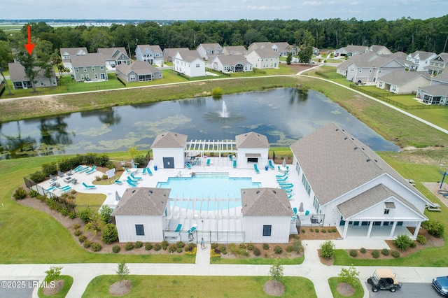 drone / aerial view with a water view and a residential view