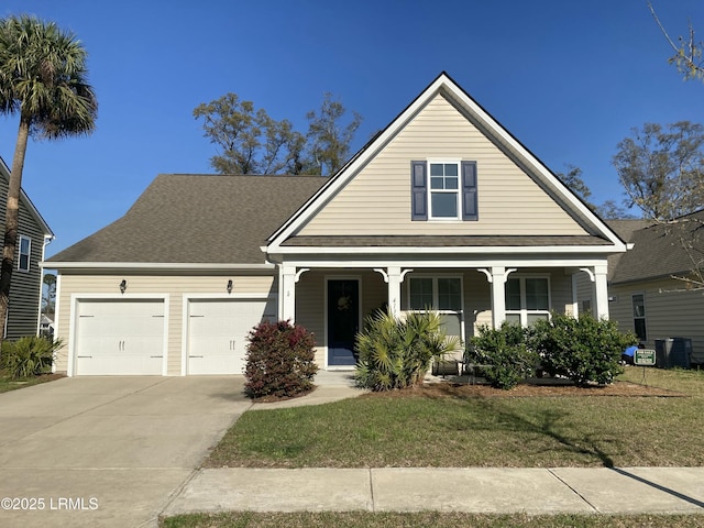 view of front of home featuring a garage, concrete driveway, a porch, and roof with shingles