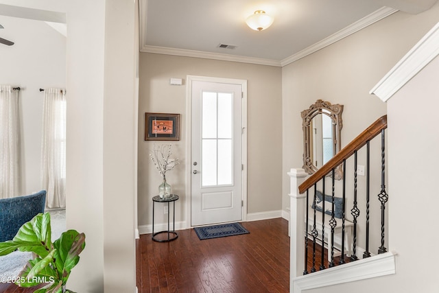 entrance foyer with stairs, ornamental molding, baseboards, visible vents, and wood finished floors