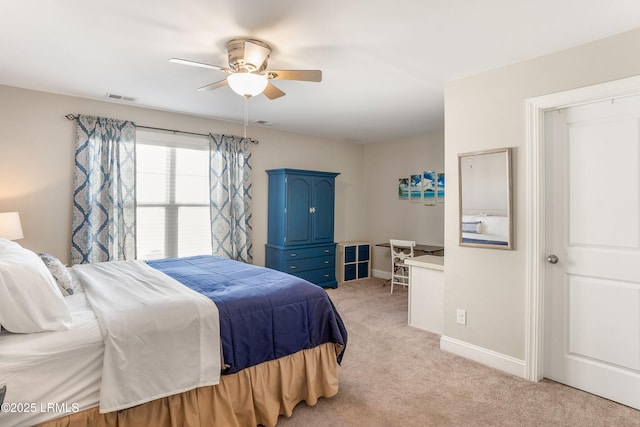 bedroom featuring light colored carpet, visible vents, baseboards, and a ceiling fan