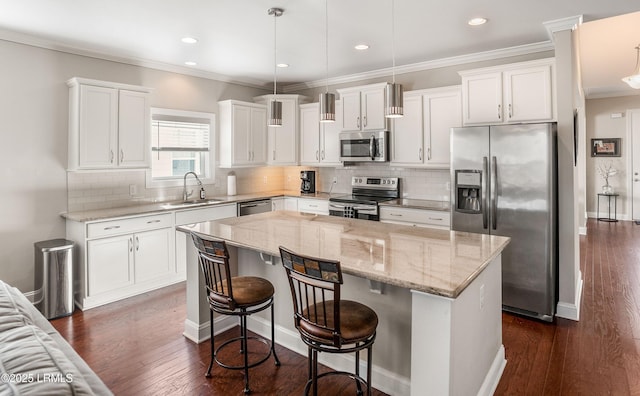 kitchen featuring a kitchen island, a sink, dark wood-style floors, white cabinets, and appliances with stainless steel finishes