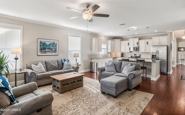 living area featuring ceiling fan, ornamental molding, and dark wood-style flooring