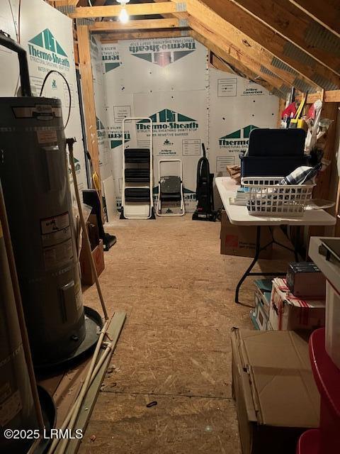 unfinished attic featuring electric water heater