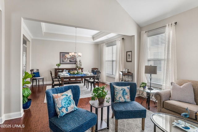 living area with baseboards, wood finished floors, a tray ceiling, vaulted ceiling, and a notable chandelier