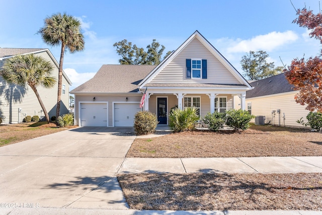view of front of house with driveway, a shingled roof, covered porch, and a garage