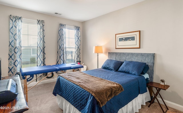bedroom featuring baseboards, visible vents, and carpet flooring