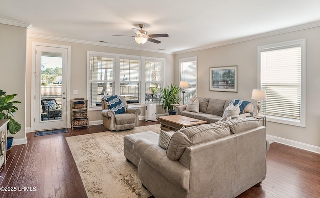 living area featuring baseboards, crown molding, a ceiling fan, and dark wood finished floors
