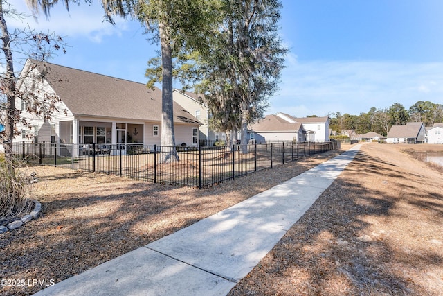 view of yard featuring a patio, fence, and a residential view