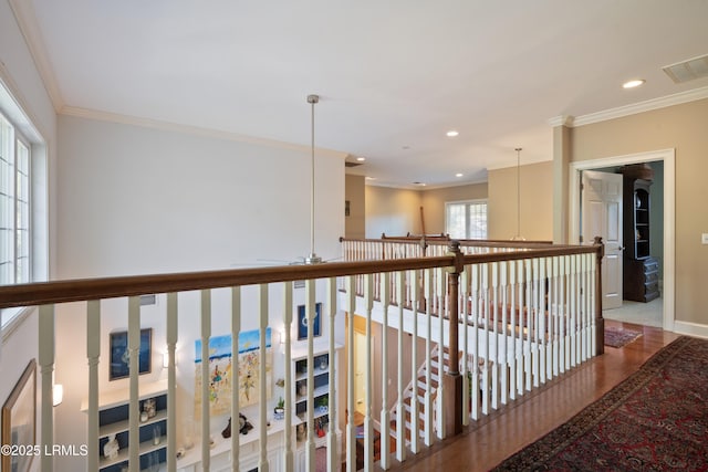 corridor featuring recessed lighting, visible vents, baseboards, and ornamental molding