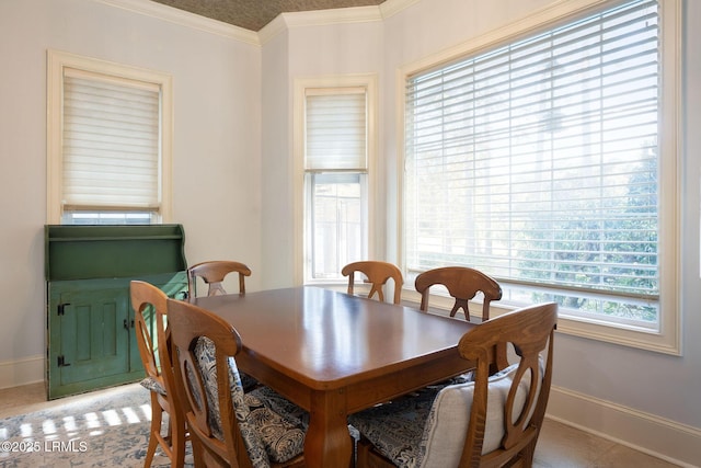 dining space with crown molding and baseboards