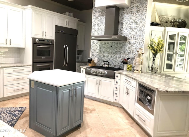 kitchen featuring wall chimney range hood, white cabinetry, appliances with stainless steel finishes, and gray cabinets