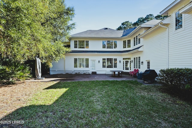 rear view of property featuring a patio and a yard