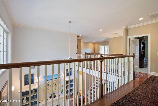 corridor with recessed lighting, visible vents, baseboards, and ornamental molding