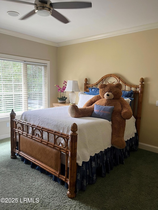 carpeted bedroom featuring baseboards, a ceiling fan, and crown molding