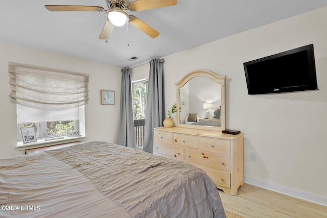 bedroom with ceiling fan and light wood-type flooring