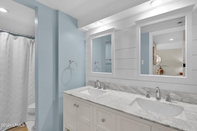 bathroom with vanity, toilet, and curtained shower