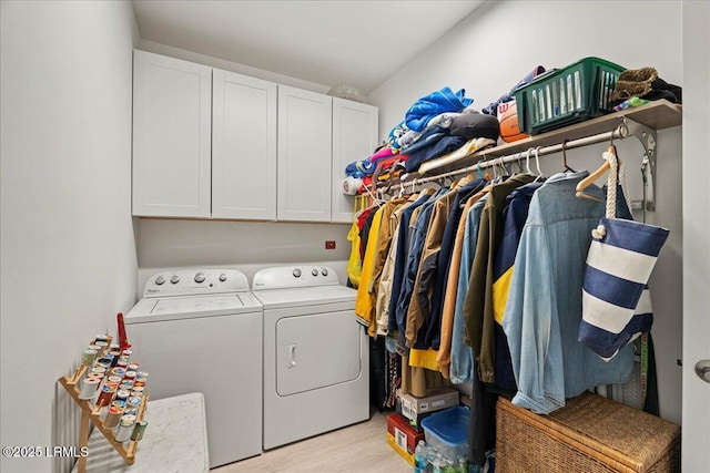 laundry area featuring cabinets, independent washer and dryer, and light wood-type flooring