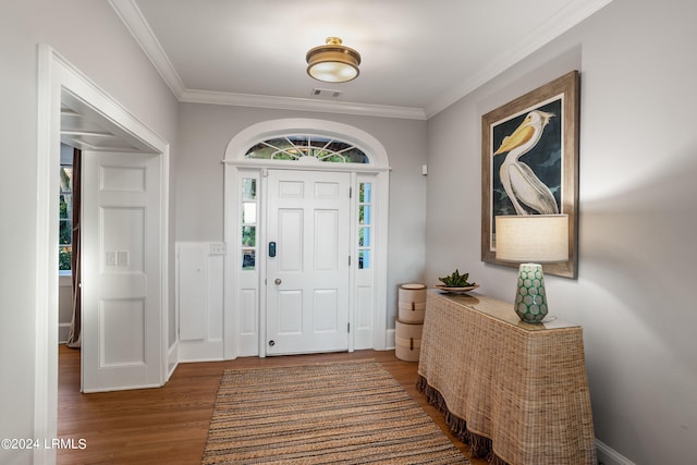 entrance foyer with crown molding, hardwood / wood-style flooring, and plenty of natural light