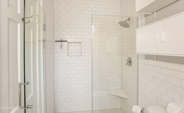 bathroom with toilet, tile walls, and walk in shower