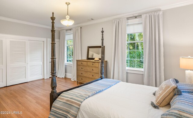 bedroom featuring crown molding and hardwood / wood-style floors