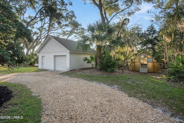 exterior space with a garage and an outbuilding