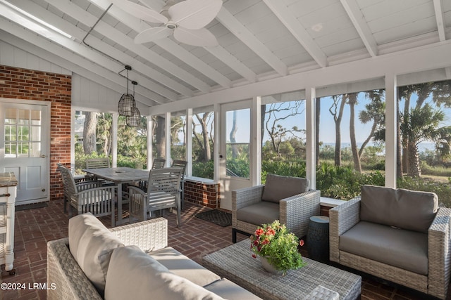 sunroom / solarium with lofted ceiling with beams and ceiling fan