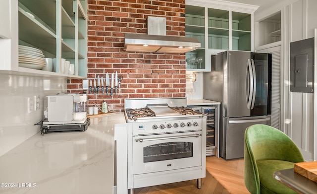 kitchen featuring stainless steel refrigerator, ventilation hood, light parquet floors, high end white range oven, and electric panel